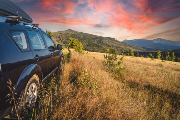 car for traveling with a mountain road. Dramatic sky
