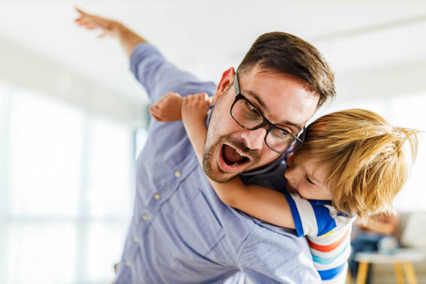 istock Playful father and son having fun while piggybacking at home. 2171320210