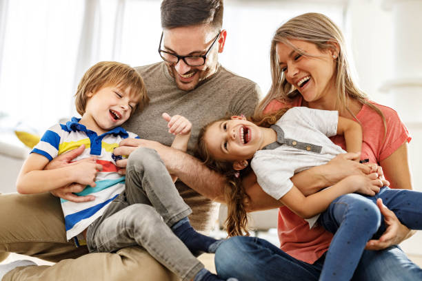istock Cheerful parents having fun with their kids at home. 2171320730