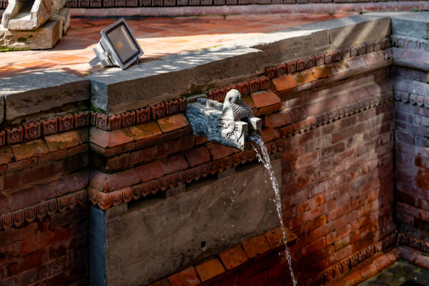Lovely architectural corner and brick made fountain with shadows