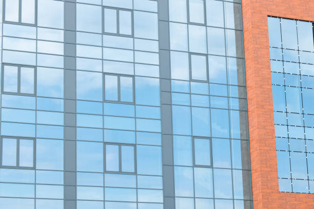 istock modern building architecture design glass exterior facade wall frame work with red brick vivid orange color square shape objects futuristic city scape local view 2171325174