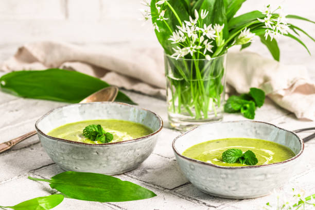 istock Two bowls of wild garlic soup on light gray background 2171328172