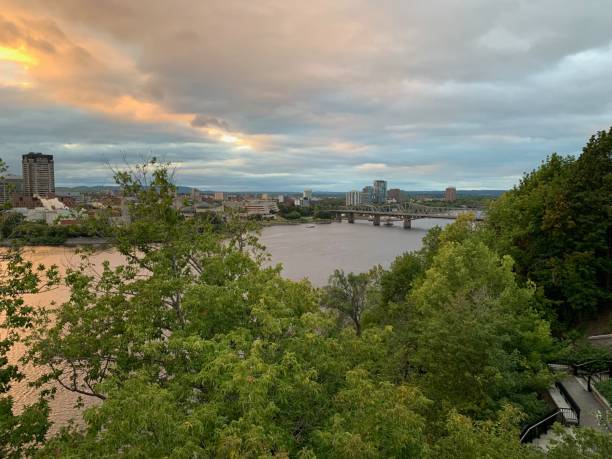 istock City Overlooking River at Sunset with Bridge 2171331002
