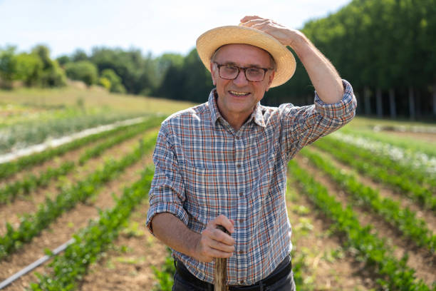 istock Front view of farmer working in his cultivated field 2171331800