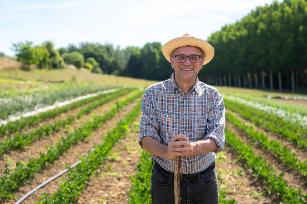 istock Front view of farmer working in his cultivated field 2171331825