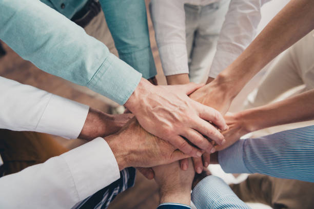 istock Cropped photo of teamwork people working together hold hands help comfortable modern office loft room interior indoors workspace 2171332745