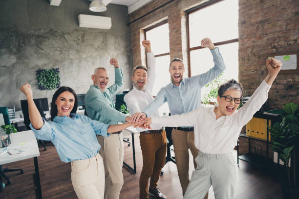 istock Photo of teamwork startup partners hold hands support winning comfortable nice creative startup office loft room interior 2171332747