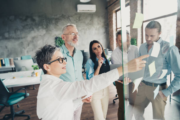 istock Photo of teamwork people work together business plan brainstorming sticky notes comfortable office loft room interior indoors workspace 2171332925