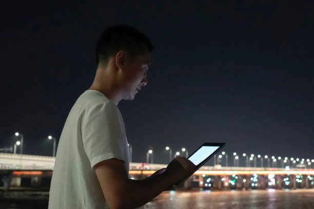 istock The man standing on the shore uses a tablet computer 2171335335