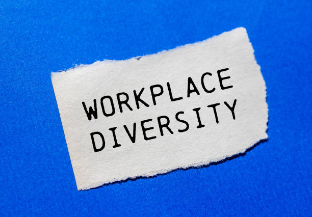 istock Workplace diversity message written on ripped torn paper piece on blue background 2171337534