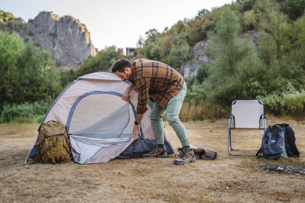 istock Adult man setting up a tent ready for camping trip at forest 2171337791