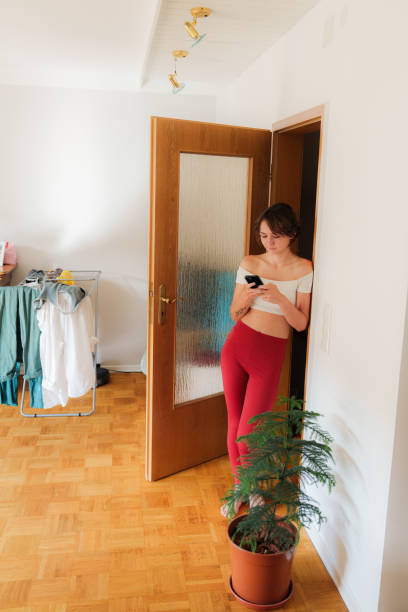 istock Woman using smartphone after doing chores on the weekends 2171341082