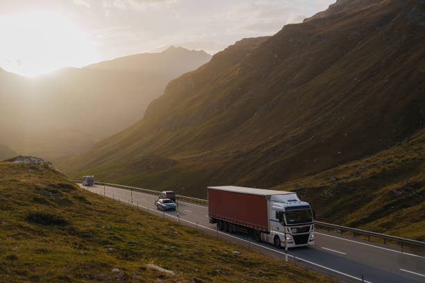 istock Cargo container truck  on road through Alps in autumn 2171341221