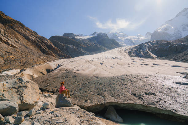 Woman exploring glacier in Swiss Alps  in autumn during the hike