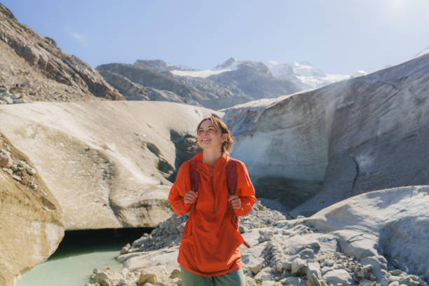 istock Woman exploring glacier ice cave  in Swiss Alps 2171341395