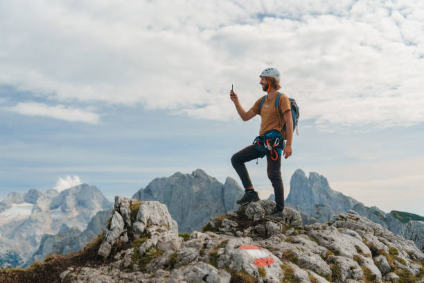 istock Man using smartphone on top of mountain after climbing 2171341600
