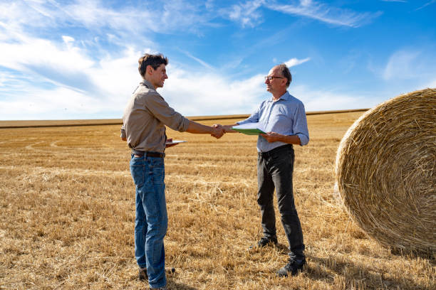 istock Farmer having a conversation with precision farming expert while standing next to hay bales 2171341639