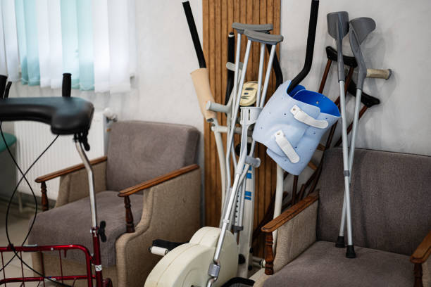 Corner of a medical room with assorted crutches, orthopedic braces, and mobility aids. The setting suggests a rehabilitation or healthcare environment, emphasizing support and recovery tools.