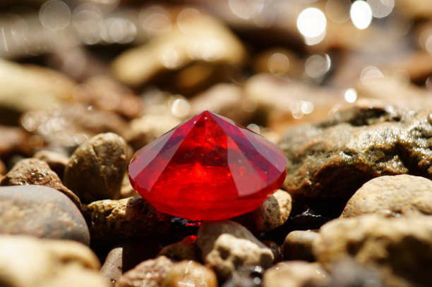 istock A red ruby on a background of stones. Jewelry. 2171344975