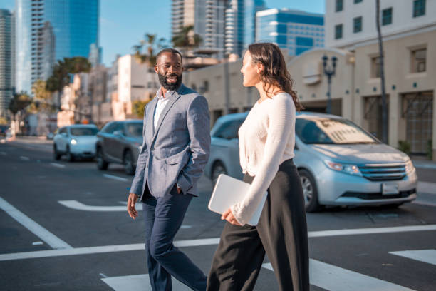 istock Dynamic Business Duo Walking in San Diego Cityscape 2171348054