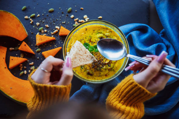 istock Female Eating  warm pumpkin broth 2171348064