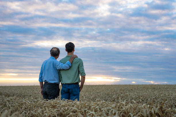 istock Farmer walking in cultivated fields with son 2171348747