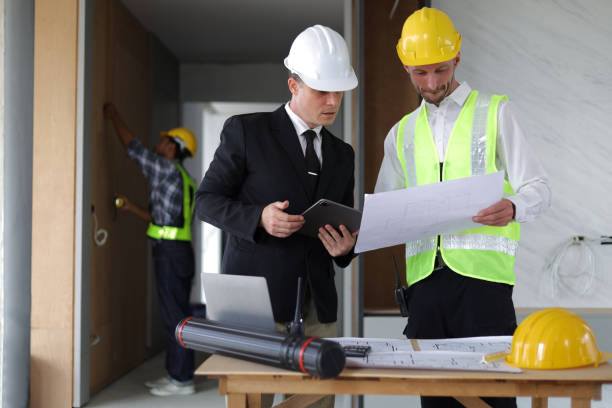 istock Businessman, contractors and engineers working at construction sites are construction inspector and supervise the work according to plans. Coworker cooperation and teamwork to ensure workplace safety. 2171349338