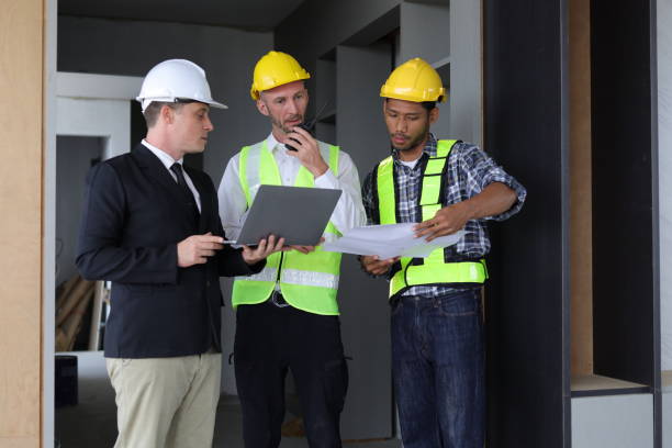 istock Businessman, contractors and engineers working at construction sites are construction inspector and supervise the work according to plans. Coworker cooperation and teamwork to ensure workplace safety. 2171349346