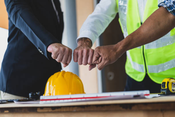 istock Businessman, contractors and engineers working at construction sites are construction inspector and supervise the work according to plans. Coworker cooperation and teamwork to ensure workplace safety. 2171349355