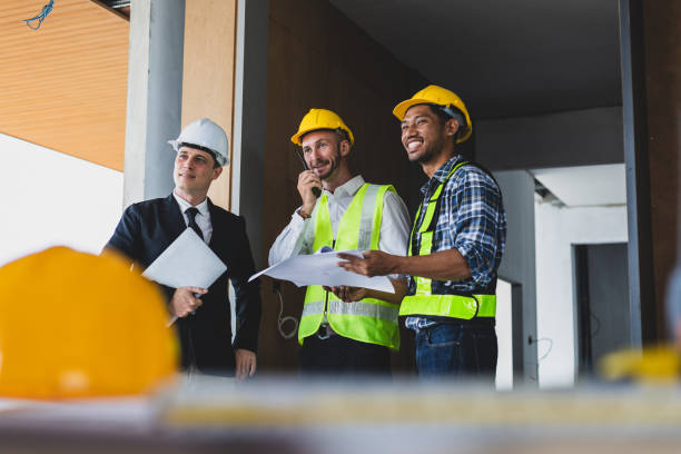 istock Businessman, contractors and engineers working at construction sites are construction inspector and supervise the work according to plans. Coworker cooperation and teamwork to ensure workplace safety. 2171349368