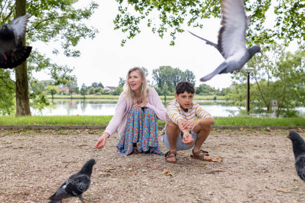 istock Mother and Son Feeding Birds 2171349823
