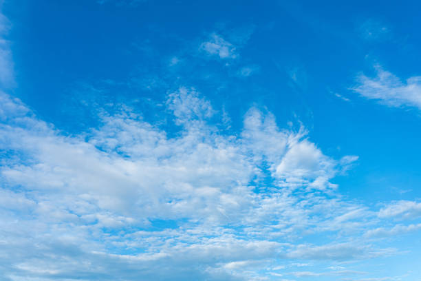 istock Beautiful cloudscape against a clear blue sky, bathed in soft sunlight 2171351434