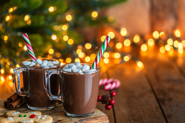 istock Two hot chocolate mugs with defocused Christmas lights at background 2171352510