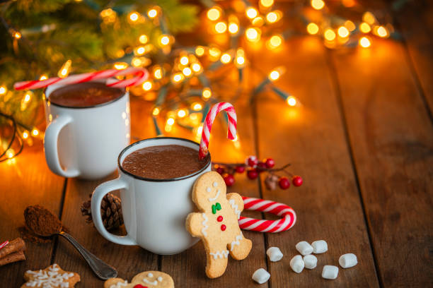 istock Two hot chocolate mugs and Christmas cookies on rustic wooden table 2171354109