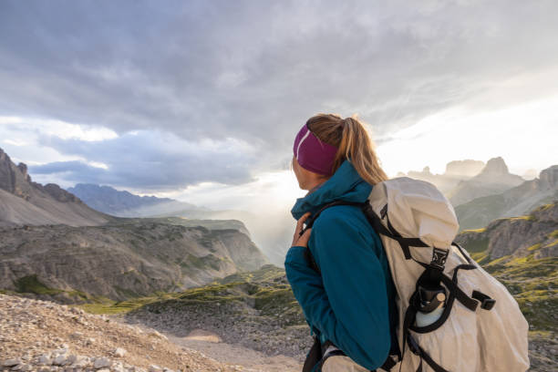 istock Female Hiker Admiring Scenic Mountain View at Sunset 2171354424