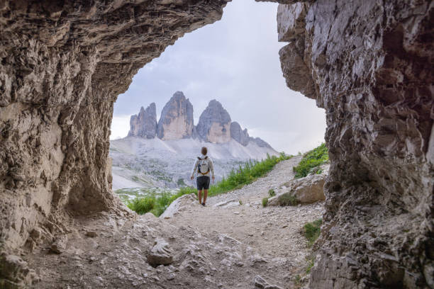 istock Hiker standing in cave, admiring mountain view 2171355630