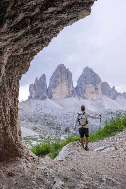 istock Hiker standing in cave, admiring mountain view 2171355639