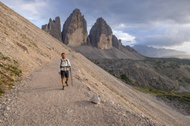 istock Hiker walking along mountain trail in the Dolomites at sunset 2171356007