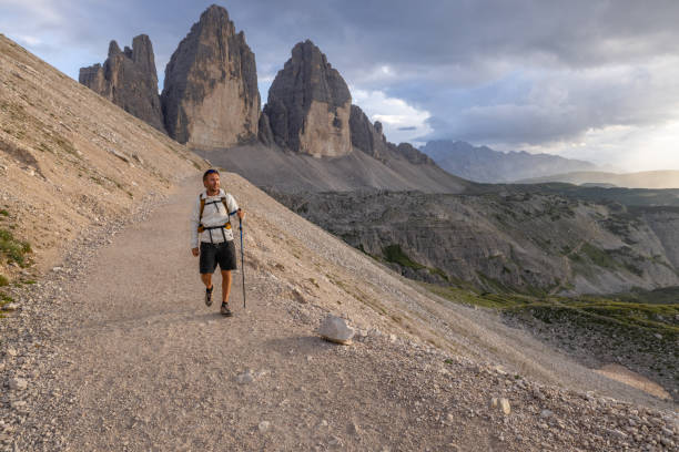 istock Hiker walking along mountain trail in the Dolomites at sunset 2171356018