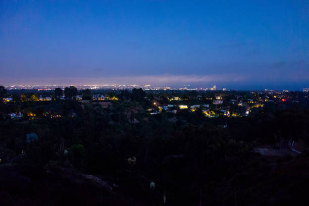 Evening lights coming on during blue hour after sunset in Los Angeles seen from Will Rogers Park