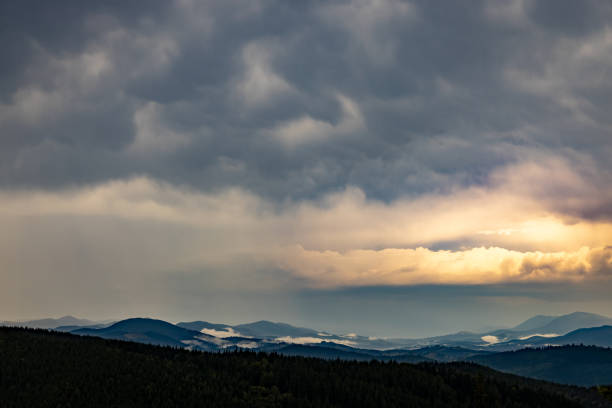 The most beautiful landscape with peaks in the background, sky with clouds at sunset.