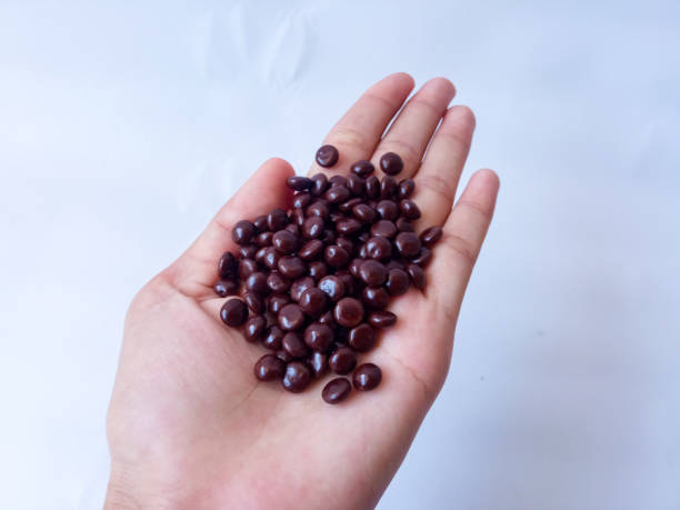 istock Chocolate coated peanut candy or chocolate balls isolated on white background 2171358008