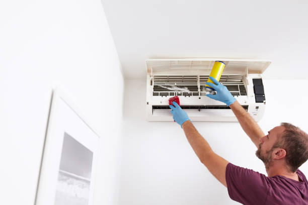 istock Man cleaning and maintaining air condition unit at home. 2171358412