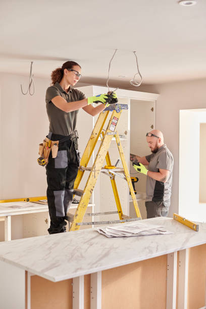 female electrician at kitchen remodelling stock photo