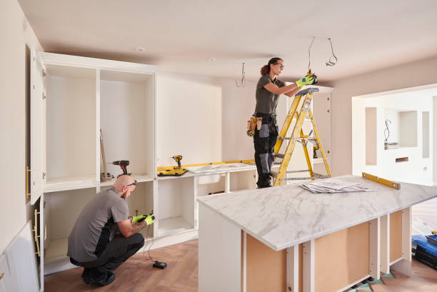 istock female electrician at kitchen remodelling 2171361453