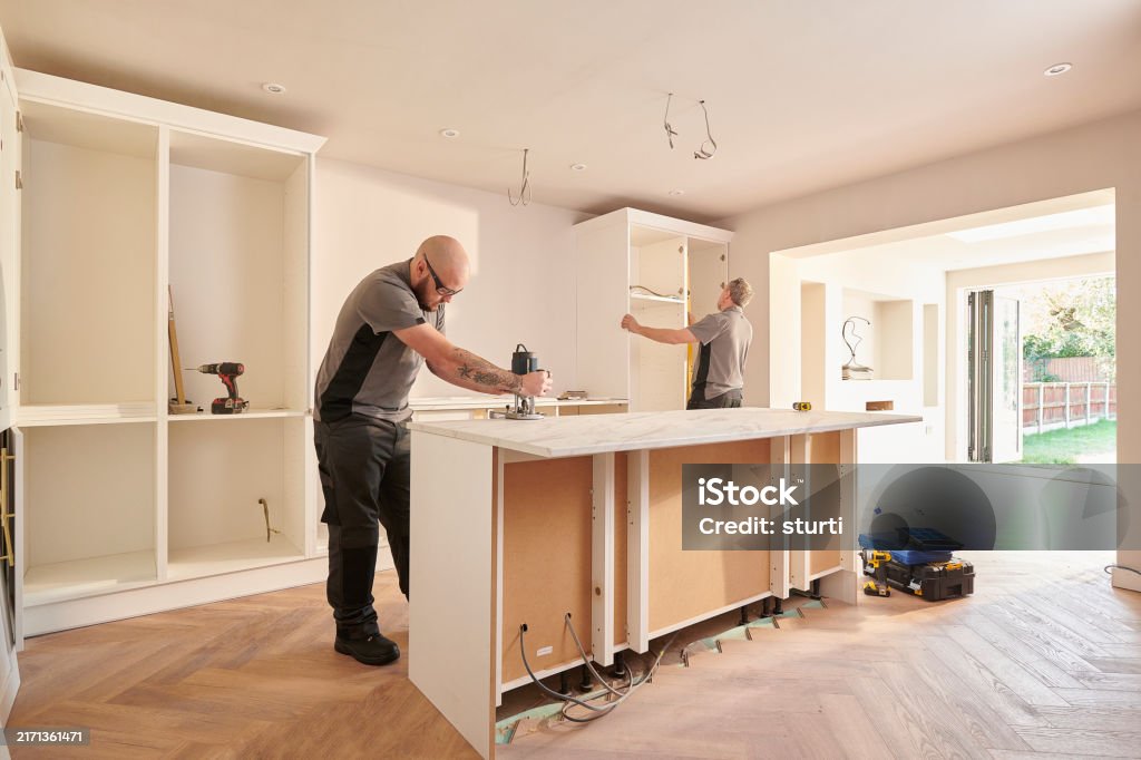 Kitchen Fitting Team Installing Stock Photo - Download Image Now - 30 ...