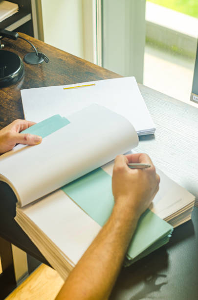 istock Man writing on notebook in the home office. The view from the top. 2171361500