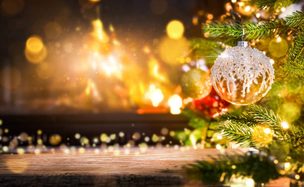 istock Decorated Christmas Tree with Red and Gold Ornaments next to a Warm Fireplace 2171361568