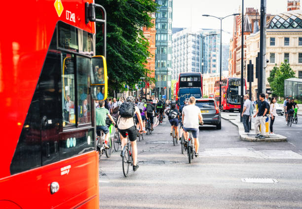 London, UK - Cyclists, buses, cars and pedestrians all using the street at rush hour in central London.