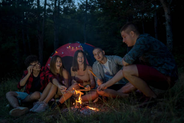 istock Friends on a camping trip relaxing by their tent 2171366686